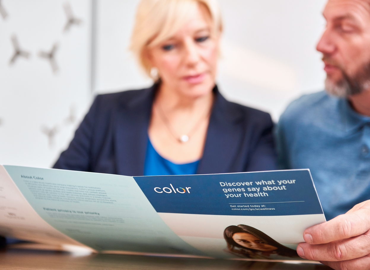 Man and woman sitting together looking at a Color brochure